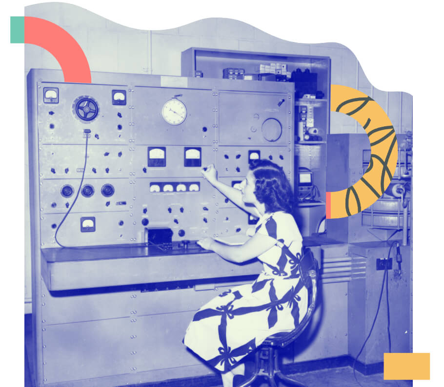 A computer room circa 1970s with a woman working a switchboard