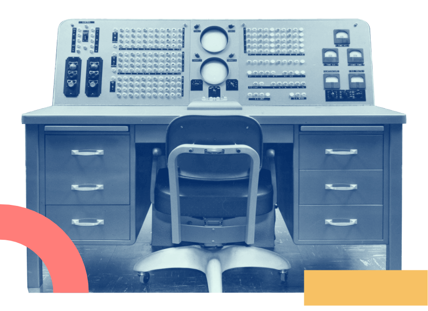 Vintage photo of a old mainframe computer with a desk.